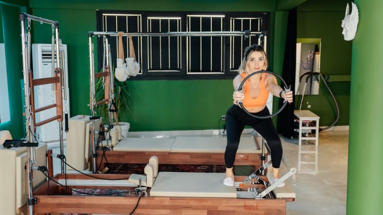 Woman is working out at a pilates studio.