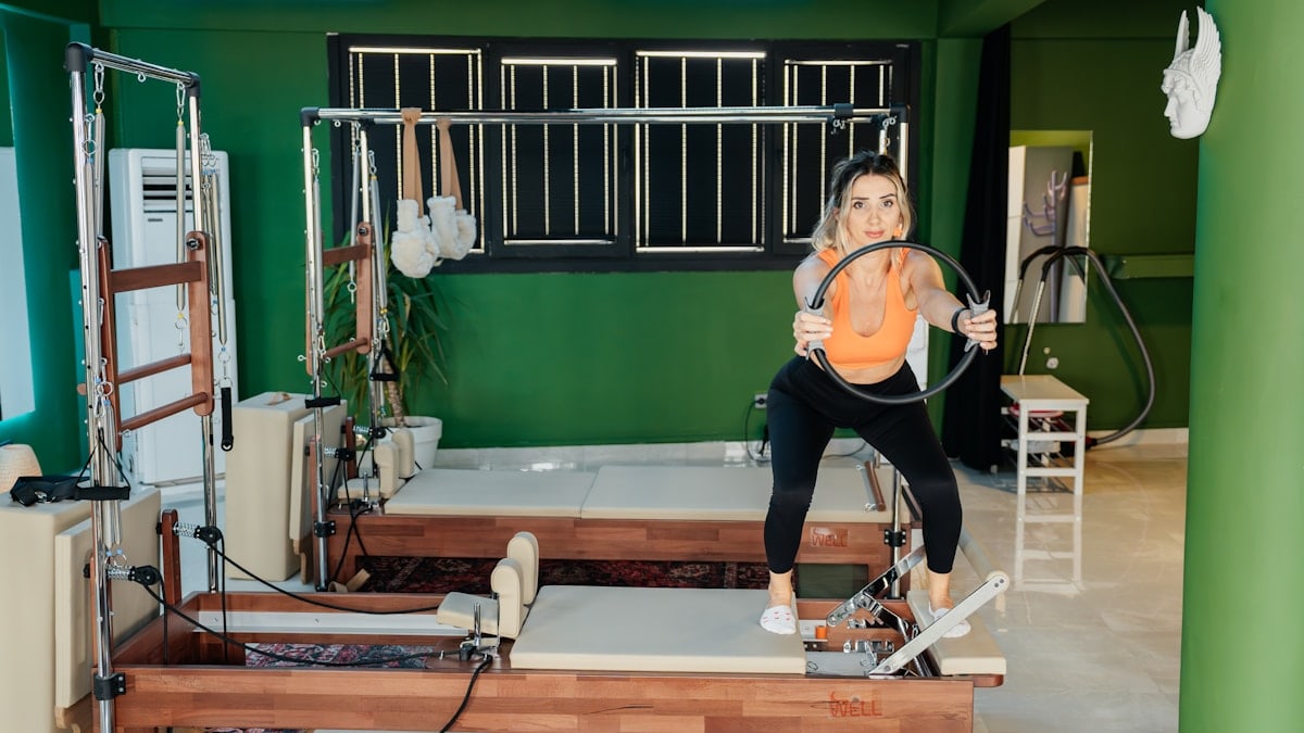 Woman is working out at a pilates studio.