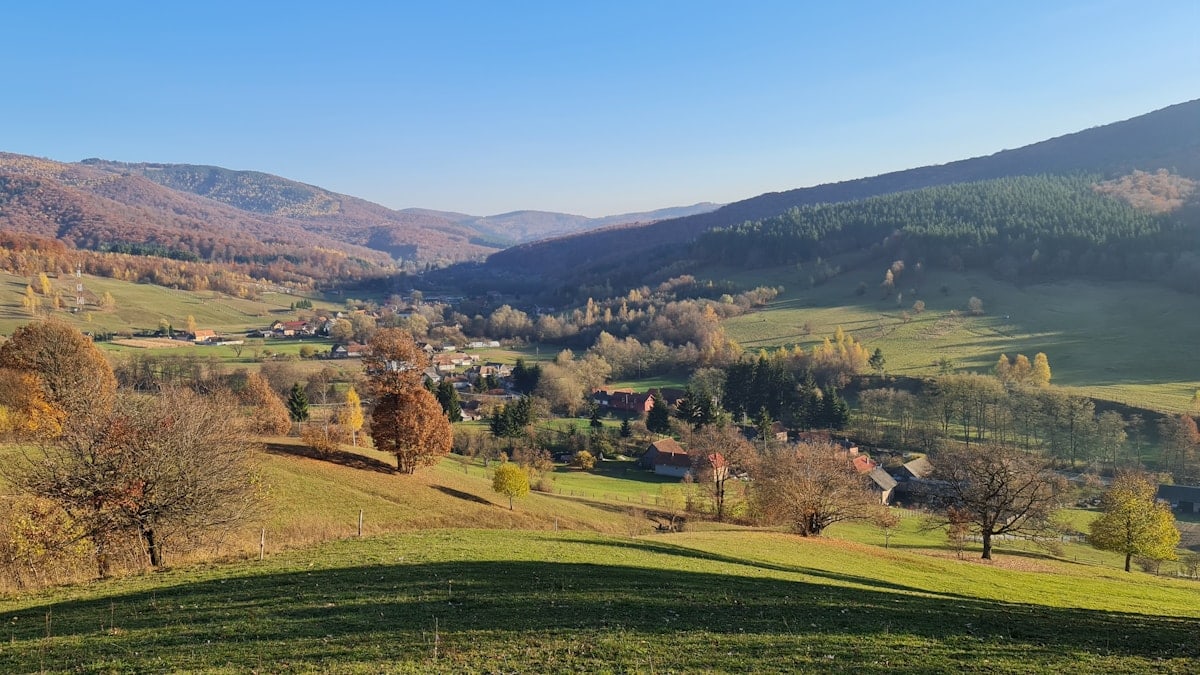 a scenic view of a valley in the mountains